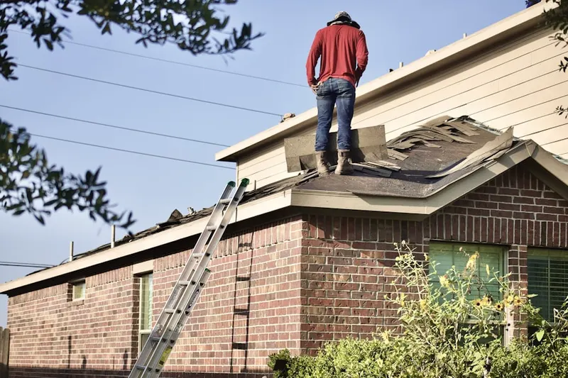 Professional roofer working on a residential roof in Webster